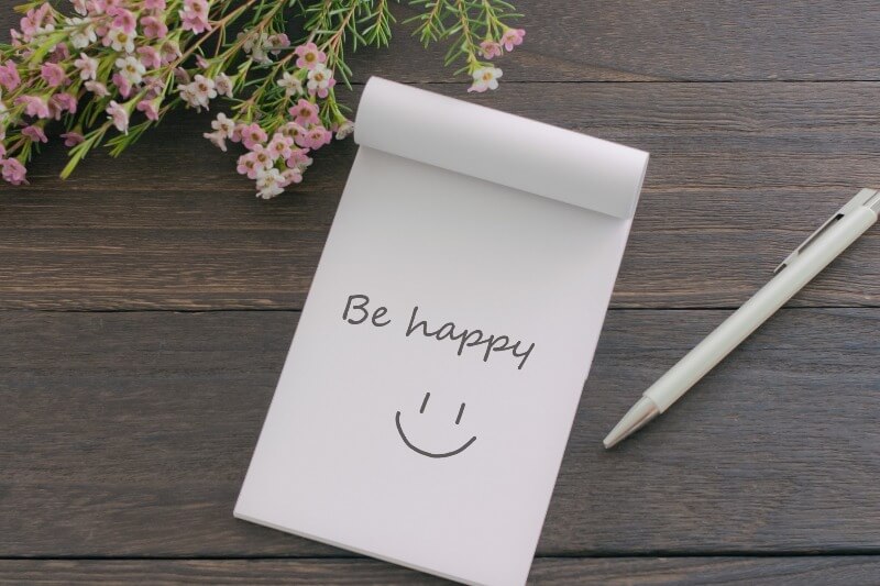 メモ帳に「Be happy」とスマイル